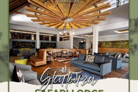 Salon w holu Skukuza Safari Lodge pod sufitem z drewnianych listew ułożonych w gwiazdę, z nałożoną nazwą obiektu